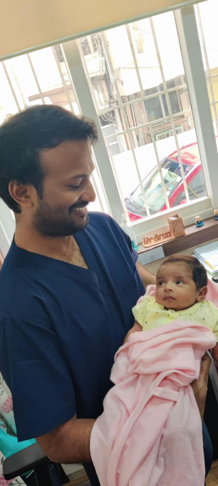 Couple with newborn visiting Dr. Arun Muthuvel after successful fertility treatment in Chennai